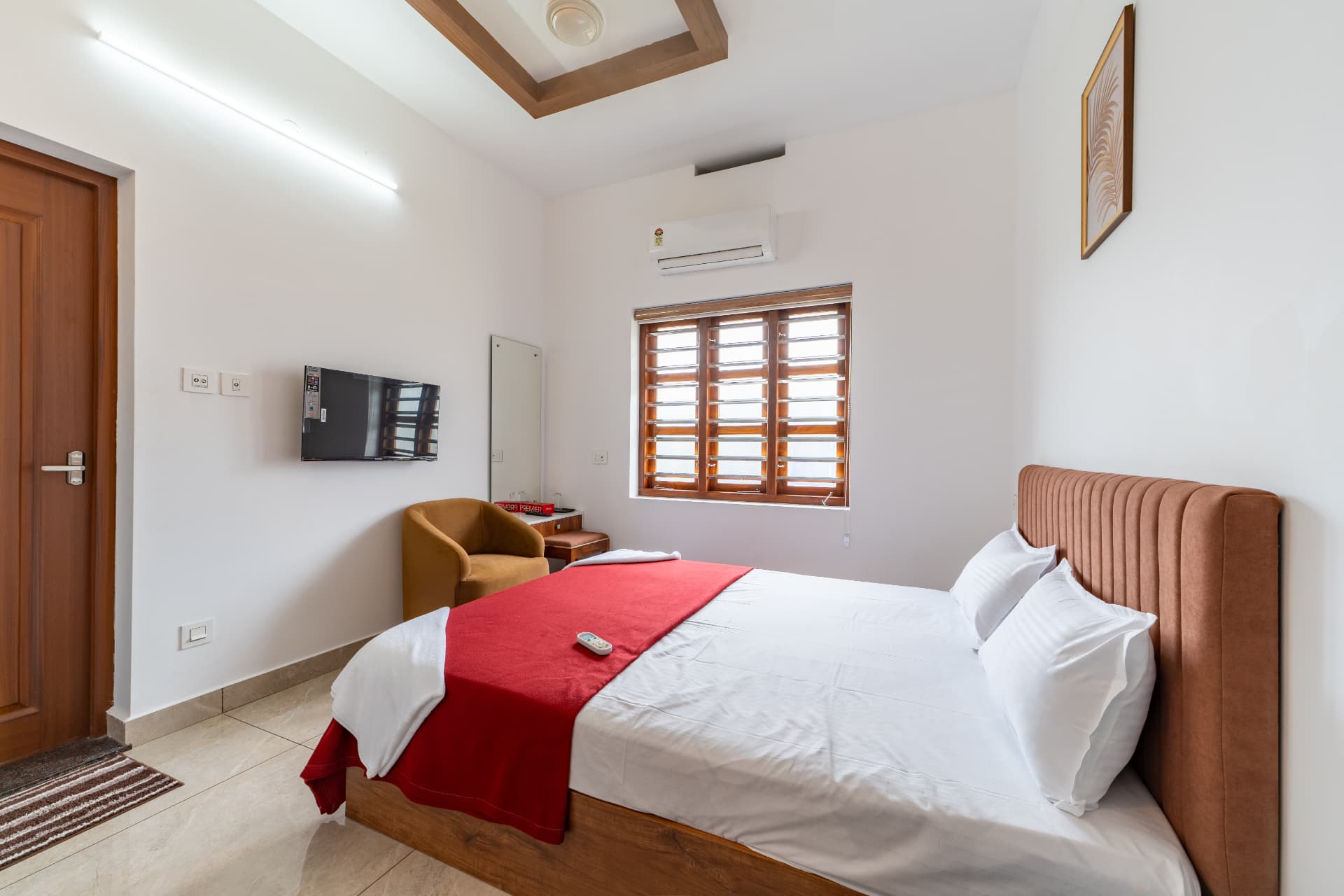Bedroom with TV, work desk and armchair